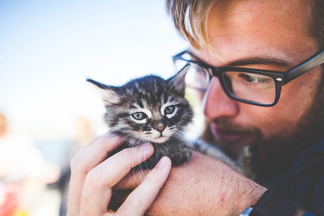 a man holding his kitten