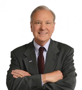 image of a man wearing a suit smiling and his arms crossed